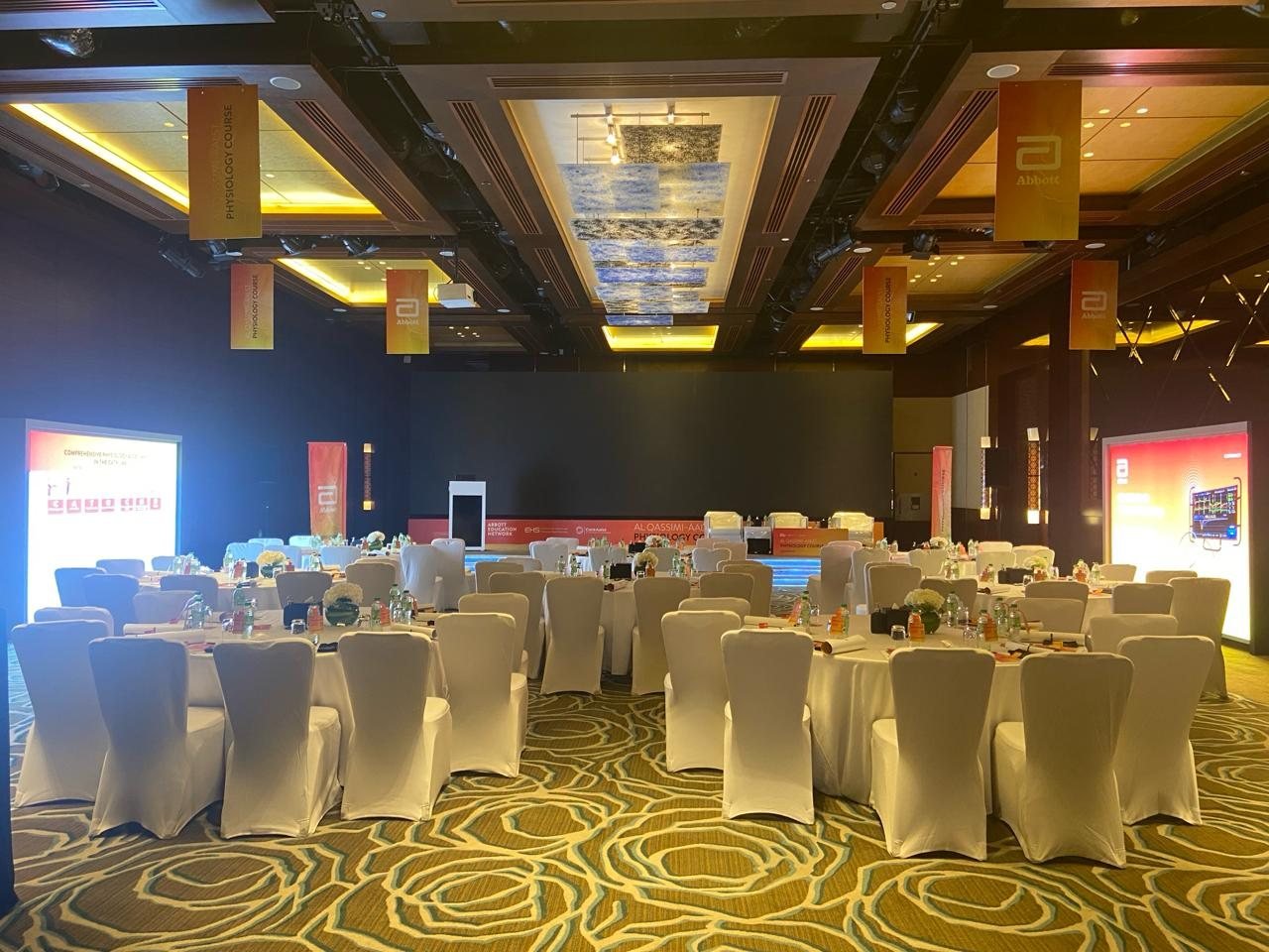 Abbott hanging banners in a conference ballroom