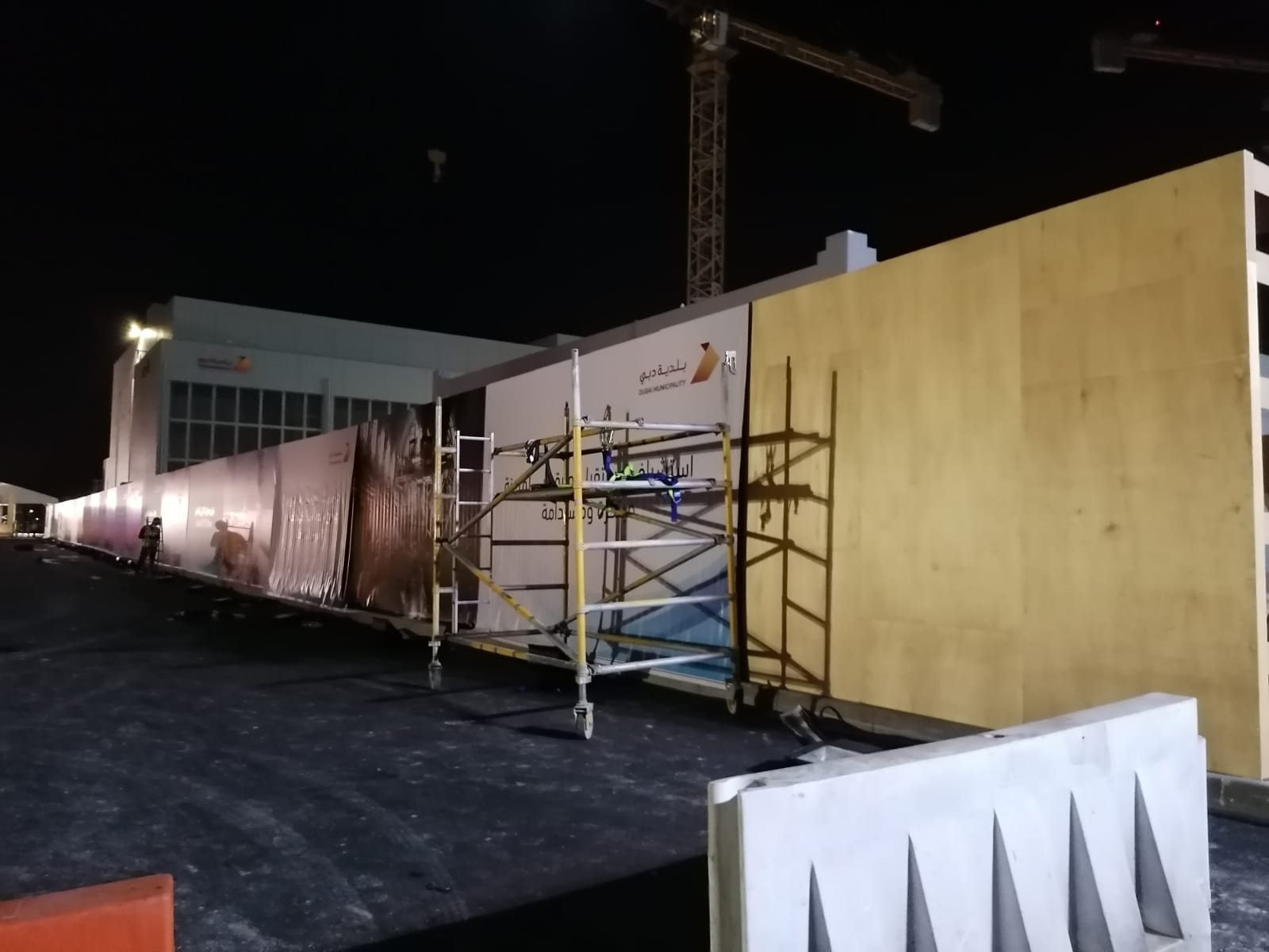 Dubai Municipality printed hoarding being installed at night