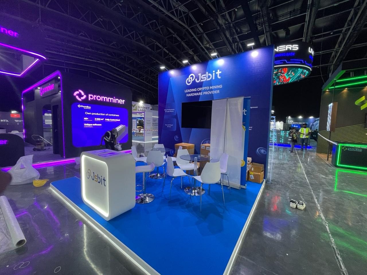 Blue Jsbit exhibition stand with printed walls and an illuminated counter