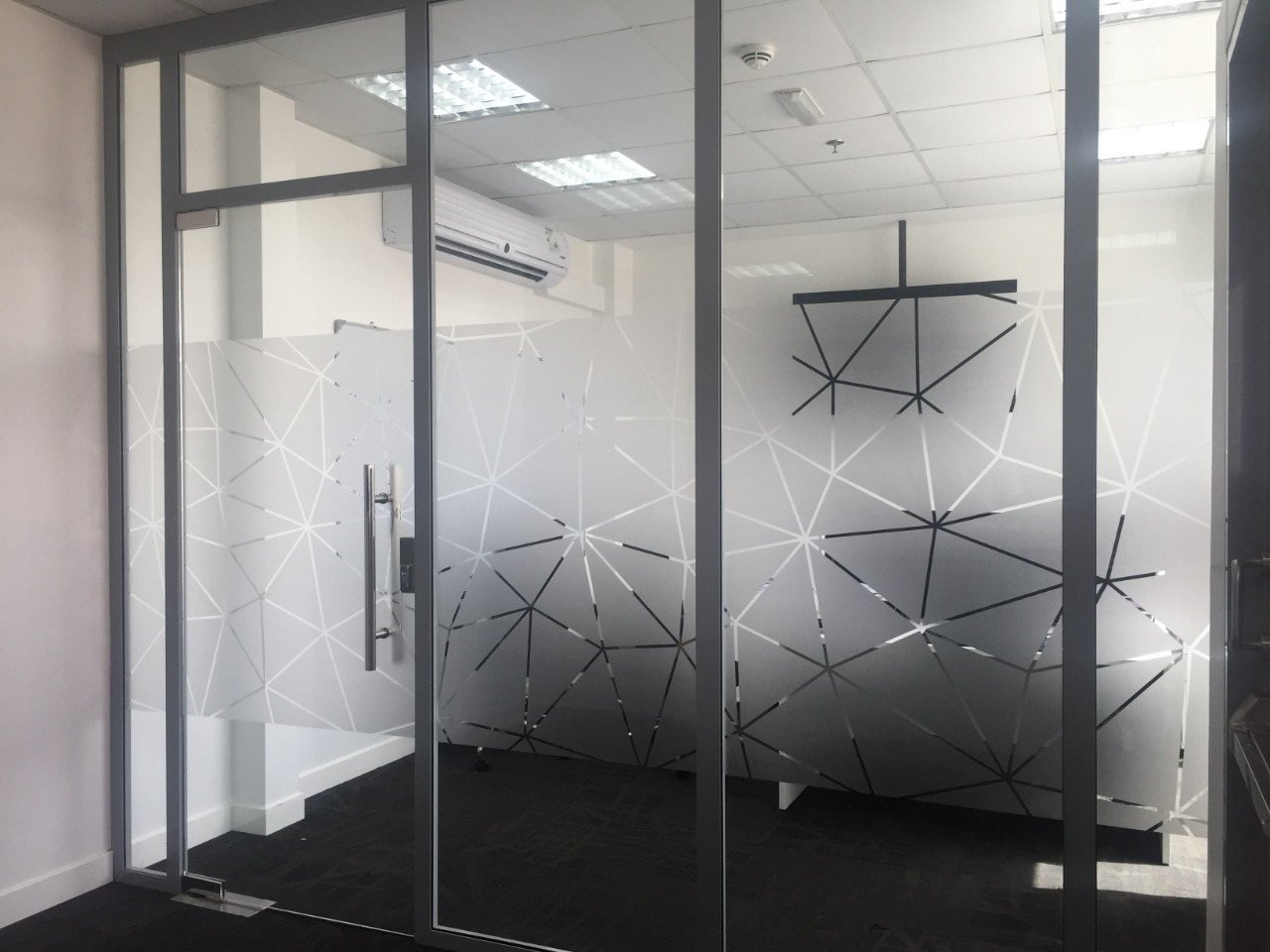 Geometric frosted film on glass meeting room partitions
