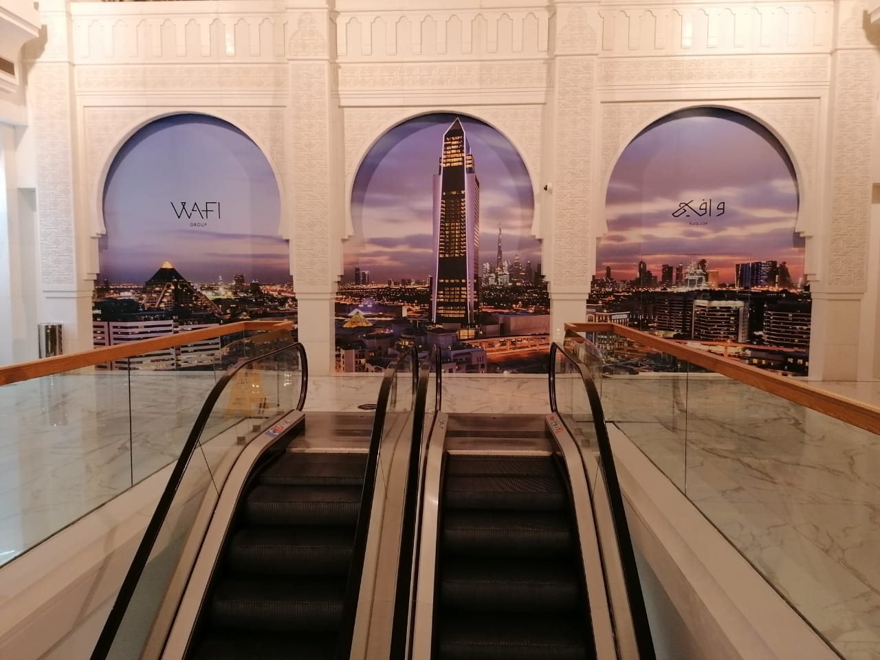 Skyline graphics on arches above mall escalators at Wafi